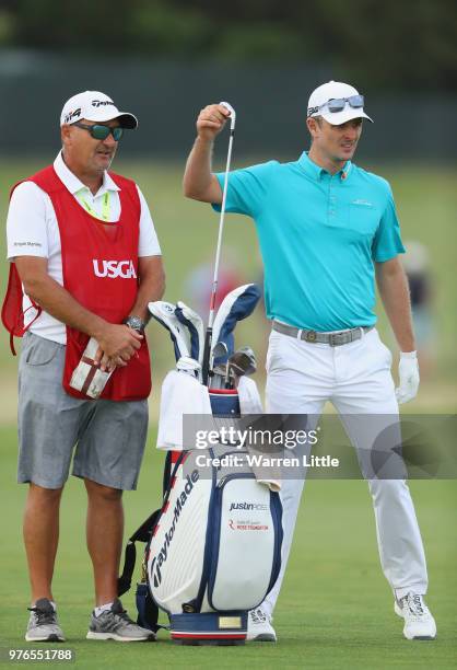 Justin Rose of England pulls a club alongside caddie Mark Fulcher during the third round of the 2018 U.S. Open at Shinnecock Hills Golf Club on June...