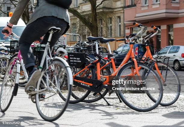 April 2018, Berlin, Germany: Bicycles of the Bike Rental Stor "Donkey Republic" standing on the Hufeland street in Prezenlauder Berg on a side walk....