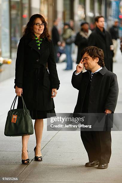 Actors Tina Fey and Peter Dinklage stand on location during filming for "30 Rock" at Rockefeller Center on October 6, 2008 in New York City.