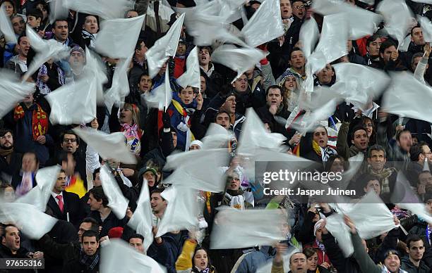 Real Madrid fans celebrate at the start of the UEFA Champions League round of 16 second leg match between Real Madrid and Lyon at the Estadio...