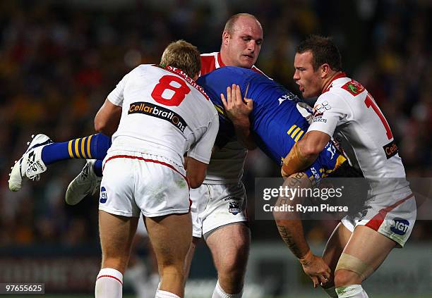 Eric Grothe of the Eels is tackled by Matt Prior , Michael Weyman and Dean Young of the Dragons during the round one NRL match between the Parramatta...