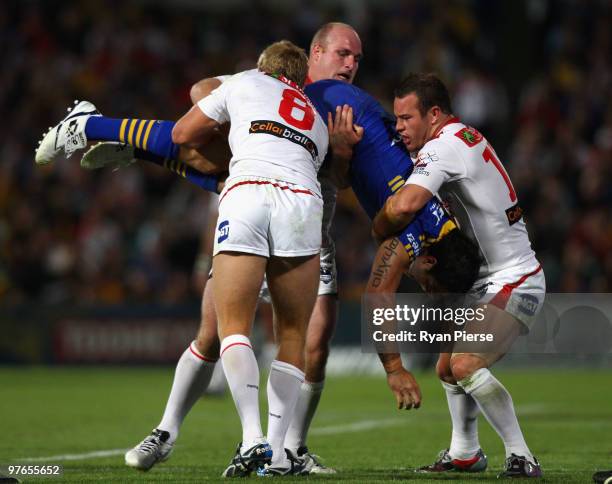 Eric Grothe of the Eels is tackled by Matt Prior , Michael Weyman and Dean Young of the Dragons during the round one NRL match between the Parramatta...