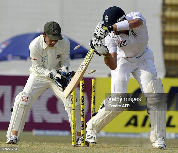 England cricketer Kevin Pietersen is bowled on 99 runs by unseen Bangladeshi bowler Abdur Razzak as wicketkeeper Mushfiqur Rahim looks on during the...