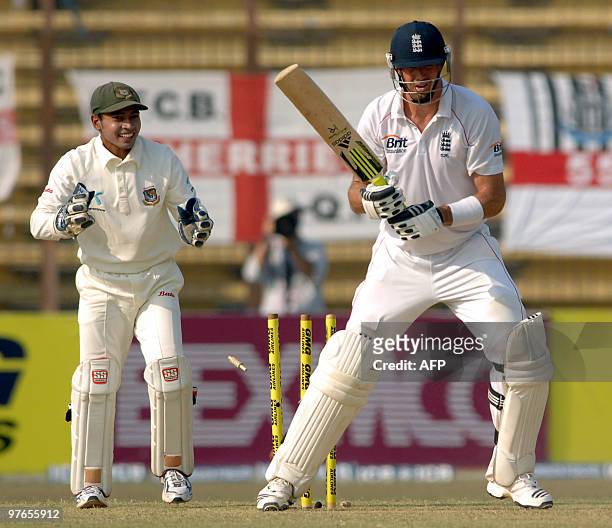 England cricketer Kevin Pietersen is bowled on 99 runs by unseen Bangladeshi bowler Abdur Razzak as wicketkeeper Mushfiqur Rahim celebrates during...