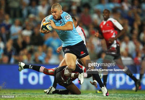 Drew Mitchell of the Waratahs makes a break during the round five Super 14 match between the Waratahs and the Lions the at Sydney Football Stadium on...