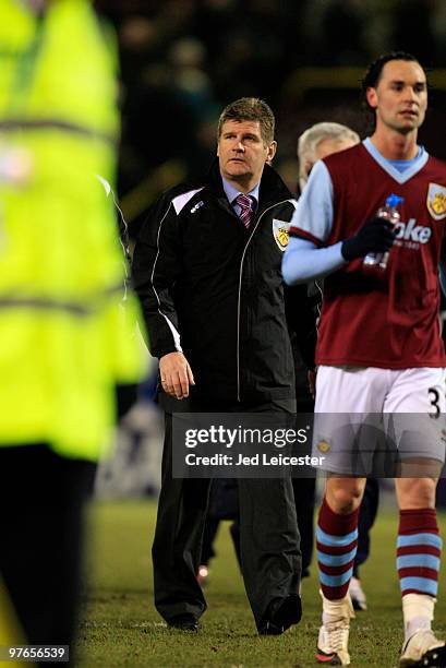 Burnley manager Brian Laws walks off the the pitch inbetween the players and toward his police escort during the Barclays Premier League match...