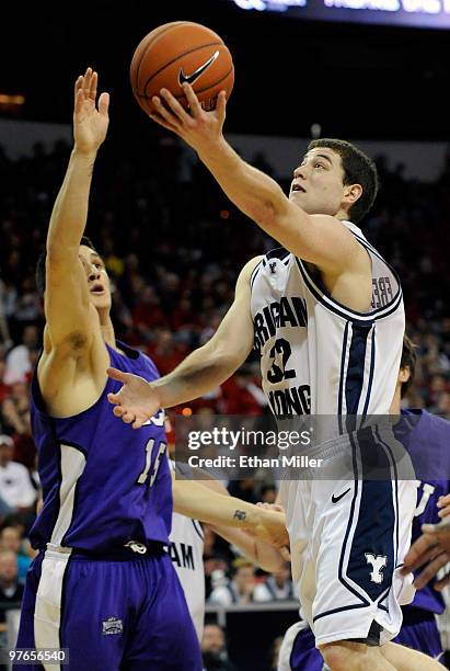 Jimmer Fredette of the Brigham Young University Cougars goes in for a layup against Zvonko Buljan of the Texas Christian University Horned Frogs...