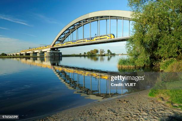 railway bridge with train - railway bridge stockfoto's en -beelden