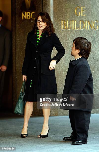 Actors Tina Fey and Peter Dinklage stand on location during filming for "30 Rock" at Rockefeller Center on October 6, 2008 in New York City.