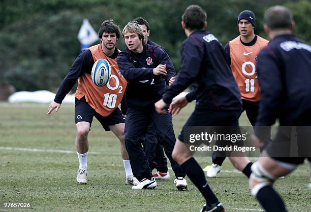 Mathew Tait passes the ball out to teammates during the England rugby union squad training session at Pennyhill Park on March 12, 2010 in Bagshot,...