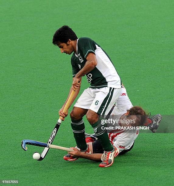 Canadian hockey player Rob Short in action against Pakistan hockey player Waseem Ahmed during their World Cup 2010 match for 11th and 12th place at...