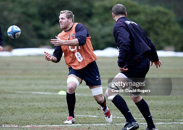 James Haskell passes the ball as Steve Borthwick closes in during the England rugby union squad training session at Pennyhill Park on March 12, 2010...