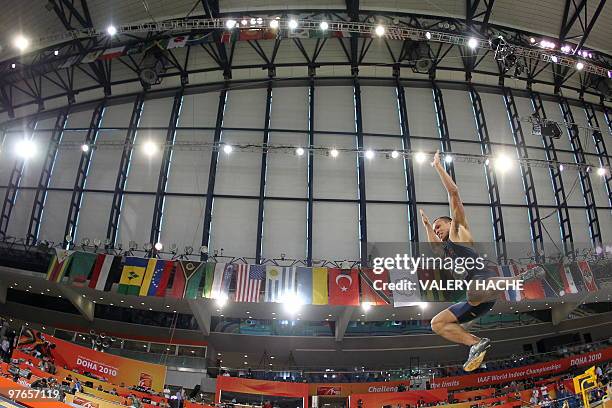 Bryan Clay competes in the men's heptathlon long jump event at the 2010 IAAF World Indoor Athletics Championships at the Aspire Dome in the Qatari...