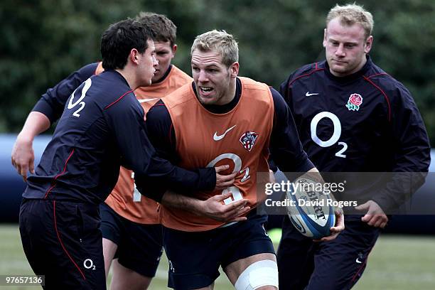 James Haskell looks to offload as he is tackled by Danny Care during the England rugby union squad training session at Pennyhill Park on March 12,...