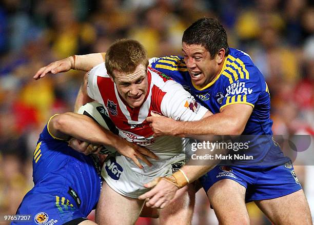 Ben Creagh of the Dragons is tackled by Nathan Cayless of the Eels during the round one NRL match between the Parramatta Eels and the St George...