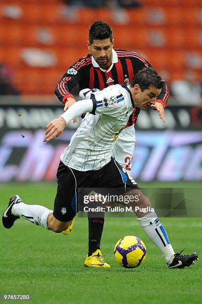 Marco Borriello of Milan and Simone Padoin of Atalanta compete for the ball during the Serie A match between Milan and Atalanta at Stadio Giuseppe...