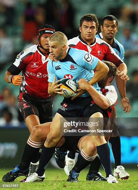 Drew Mitchell of the Waratahs is tackled during the round five Super 14 match between the Waratahs and the Lions the at Sydney Football Stadium on...