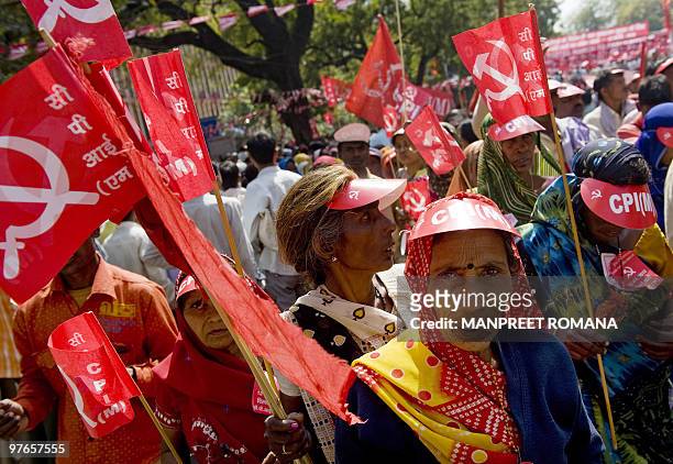 Activists of Indian left-wing parties hold flags and placards as they attend a protest rally in New Delhi on March 12, 2010. Thousands of activists...