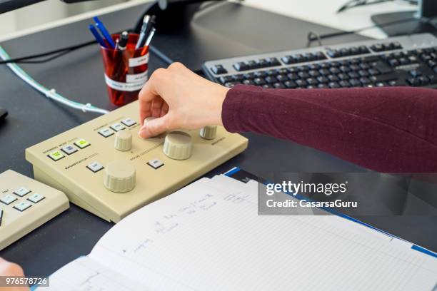 human hand on the field emission electron microscope control panel - electron microscope micrographs stock pictures, royalty-free photos & images
