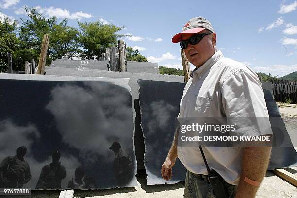 Dave van Breda, chief executive of Zimbabwe's black granite producer Natural Stone Export Company, stands infront of slates of black granite in...