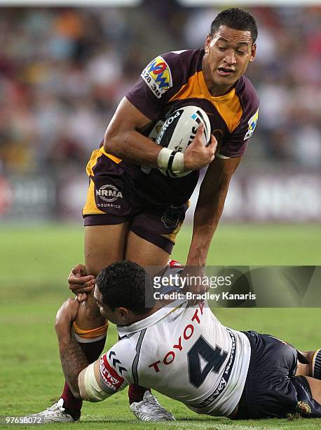 Israel Folau of the Broncos takes on the Cowboys defence during the round one NRL match between the Brisbane Broncos and the North Queensland Cowboys...
