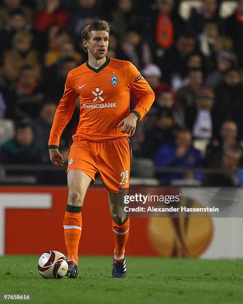 Per Mertesacker of Bremen runs with the ball during the UEFA Europa League round of 16 first leg match between Valencia and SV Werder Bremen at...