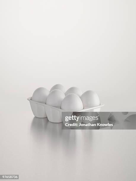 white egg holder against white background - egg white background stock-fotos und bilder