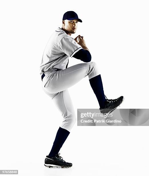 baseball player about to throw a pitch - pitcher stock-fotos und bilder