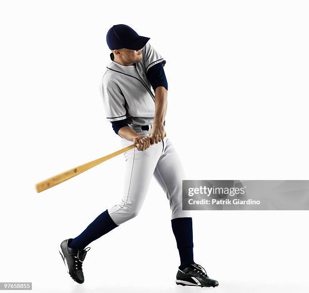 baseball player swinging bat - baseball swing stock pictures, royalty-free photos & images