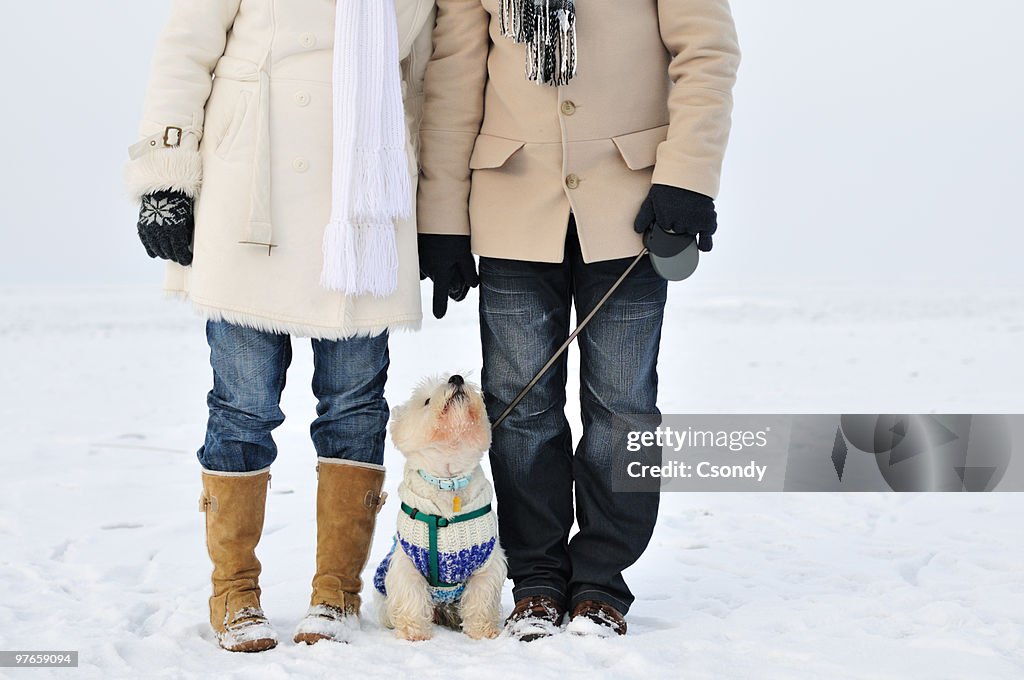 Young couple together outdoors in the snow.