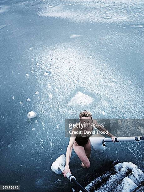 woman bathing in icy sea. - david trood stock-fotos und bilder