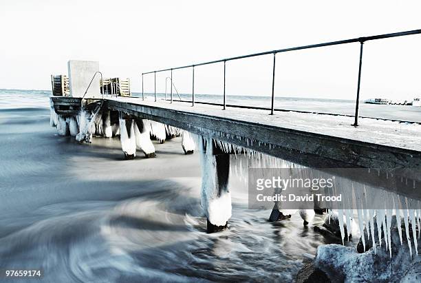 frozen jetty - david trood stock pictures, royalty-free photos & images