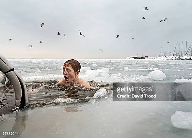 boy in frozen sea. - david trood stock-fotos und bilder