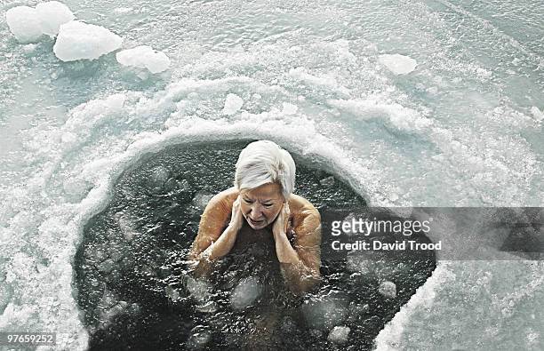 woman in icy sea - david trood stock-fotos und bilder