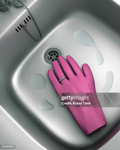 rubber glove with marriage ring in kitchen sink - rubber ring stock-fotos und bilder