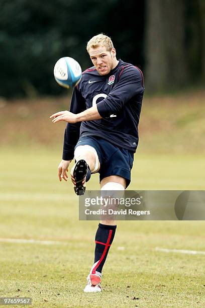 Back row forward James Haskell kicks the ball downfield during the England rugby union squad training session at Pennyhill Park on March 12, 2010 in...