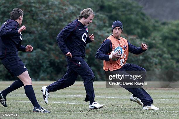 Shontayne Hape is pursued by Mathew Tait and Toby Flood during the England rugby union squad training session at Pennyhill Park on March 12, 2010 in...