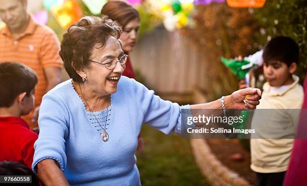 hispanic grandmother prepares to hug someone - hispanic grandmother stock pictures, royalty-free photos & images