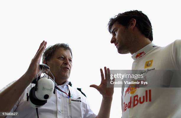 Mercedes Benz Vice President of Motorsport Norbert Haug talks to Mark Webber of Australia and Red Bull Racing before practice for the Bahrain Formula...