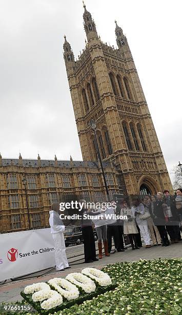 Jo Cash, Annie Lennox and Lisa B and Gareth Thomas attends 'A Minute For Mothers' photocall on March 12, 2010 in London, England.