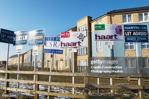 House sale signs at the Orchard Park development, Cambridge, UK.