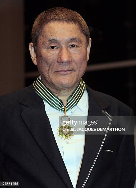 Japanese film director and artist Takeshi Kitano poses after being awarded Commander of the Order of Arts and Letters by French culture minister...