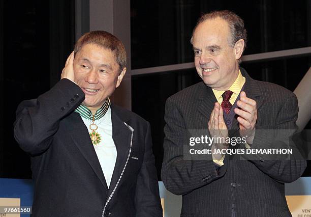 Japanese film director and artist Takeshi Kitano poses after being awarded Commander of the Order of Arts and Letters by French culture minister...