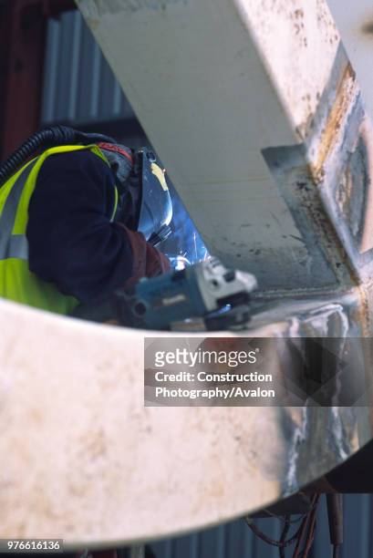 Wembley stadium-London: Cleaning up welds on the interlacing steel tubes of the signature arch, constructed on the ground by Cleveland Bridge After...