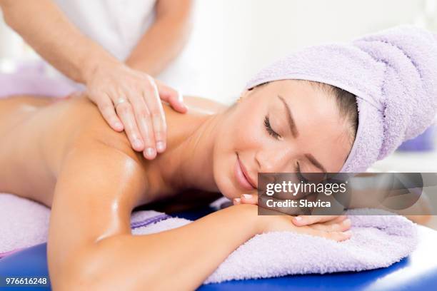 beautiful woman getting back massage - human back stock pictures, royalty-free photos & images