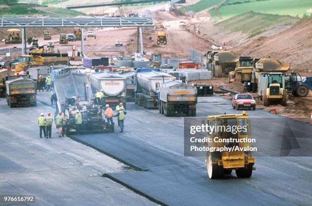 Toll road toll plaza asphalting and rolling down.