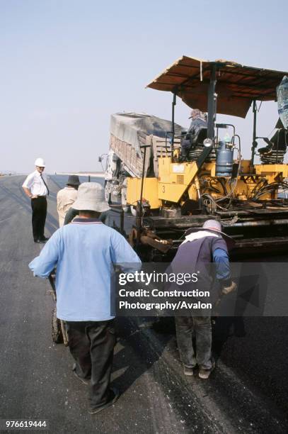 Asphalting pavers working on the top layer of the new runways at the new international Suvarnabhumi Bangkok Airport.