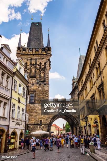 tourists in lesser town bridge towers, prague. czech republic - trdelník stock pictures, royalty-free photos & images