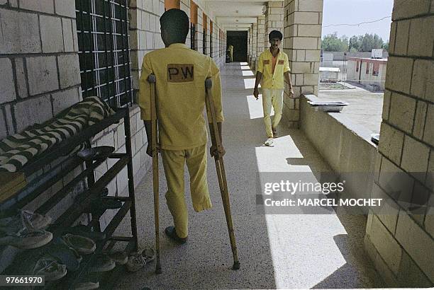Young Iranian prisoner walks on crutches 24 August 1988 in a corridor of the Ramadi prisoners camp, western Iraq. The Iraq-Iran war began in...