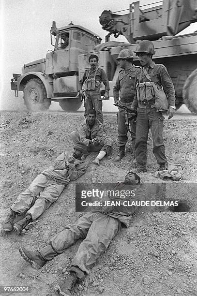 Iraqi soldiers keep a close eye on Iranian prisoners captured on the front line, south east of Tigris, 18 March 1985 during Iraq-Iran war. The...